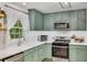 Well-lit kitchen with stainless steel appliances, custom cabinets, and a bright window over the sink at 425 Shelby Ln, Hiram, GA 30141