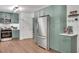 Kitchen featuring stainless steel appliances, green cabinetry, and hardwood floors at 425 Shelby Ln, Hiram, GA 30141