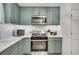 Kitchen featuring green cabinets, subway tile backsplash, and stainless steel appliances at 425 Shelby Ln, Hiram, GA 30141