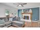 Comfortable living room with a plush gray sectional sofa, a decorative fireplace, and bright natural light at 425 Shelby Ln, Hiram, GA 30141