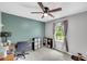 Home office with an adjustable-height desk, modern ceiling fan, and a bright window at 425 Shelby Ln, Hiram, GA 30141