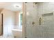Modern bathroom featuring a glass shower with gold fixtures and ceramic tile at 45 Driskell Ave, Mableton, GA 30126