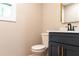 Well-lit bathroom with dark vanity, marble countertop, and matte black faucet at 45 Driskell Ave, Mableton, GA 30126