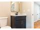 Well-lit bathroom with dark vanity, marble countertop, and matte black faucet at 45 Driskell Ave, Mableton, GA 30126