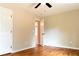 Neutral bedroom with ceiling fan, hardwood floors, and connecting door to another room at 45 Driskell Ave, Mableton, GA 30126