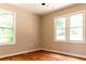 A bedroom featuring sleek hardwood floors and two large windows that bring natural light into the space at 45 Driskell Ave, Mableton, GA 30126