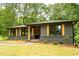 A stylish gray single-story home showing an outdoor space that is freshly cut and maintained at 45 Driskell Ave, Mableton, GA 30126