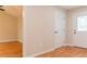 Hallway with neutral paint, hardwood floors, and access to the outdoors at 45 Driskell Ave, Mableton, GA 30126