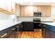 Modern kitchen featuring stainless steel appliances, sleek countertops, and two-tone cabinets with gold hardware at 45 Driskell Ave, Mableton, GA 30126