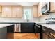 A modern kitchen featuring stainless steel appliances, white countertops, and two-tone cabinets with gold hardware at 45 Driskell Ave, Mableton, GA 30126