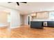 An open floor plan flows into a modern kitchen and features sleek hardwood floors and a ceiling fan at 45 Driskell Ave, Mableton, GA 30126