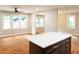 Bright living room featuring sleek hardwood floors and a view of the backyard through large windows at 45 Driskell Ave, Mableton, GA 30126