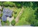 A stunning aerial view of the home featuring lush landscaping and mature trees surrounding the property at 4559 Paradise Shoals Se Rd, Atlanta, GA 30339