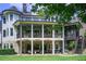 Expansive multi-level outdoor living with stone base, covered porches, and lush landscaping at 4559 Paradise Shoals Se Rd, Atlanta, GA 30339