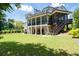 Spacious backyard featuring a lush lawn, mature trees, and a multi-level deck with a screened-in porch at 4559 Paradise Shoals Se Rd, Atlanta, GA 30339
