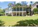Large backyard with a lush lawn, mature trees, a multi-level deck, and a screened-in porch at 4559 Paradise Shoals Se Rd, Atlanta, GA 30339