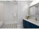 Stylish bathroom with blue vanity, modern fixtures, and patterned tile floor at 4559 Paradise Shoals Se Rd, Atlanta, GA 30339