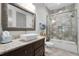 Bathroom showcasing a granite vanity, vessel sink, modern faucet, and tiled shower with a glass door at 4559 Paradise Shoals Se Rd, Atlanta, GA 30339