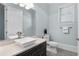 Bright bathroom featuring a square bowl sink, neutral countertops, and decorative tiled floor at 4559 Paradise Shoals Se Rd, Atlanta, GA 30339