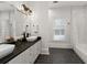 Bright bathroom features a double vanity, modern lighting and fixtures, and white subway tile at 4559 Paradise Shoals Se Rd, Atlanta, GA 30339
