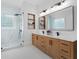Well-lit bathroom with a double vanity, walk-in shower, and sleek fixtures and finishes at 4559 Paradise Shoals Se Rd, Atlanta, GA 30339