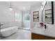 Spa-like bathroom with a soaking tub, walk-in shower, dual sinks, and contemporary lighting at 4559 Paradise Shoals Se Rd, Atlanta, GA 30339