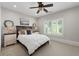A serene bedroom featuring a ceiling fan, plantation shutters, and neutral tones for a cozy and inviting atmosphere at 4559 Paradise Shoals Se Rd, Atlanta, GA 30339