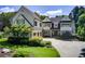 Beautiful two-story home featuring a stone chimney, well-manicured lawn and an attached three-car garage at 4559 Paradise Shoals Se Rd, Atlanta, GA 30339