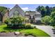 Charming home showcasing lush landscaping, mature trees, and a circular driveway at 4559 Paradise Shoals Se Rd, Atlanta, GA 30339