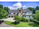 Beautiful home with a lush front lawn, mature trees, a circular driveway, and a two-car garage at 4559 Paradise Shoals Se Rd, Atlanta, GA 30339