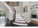 Grand foyer with a curved staircase featuring iron spindles and hardwood floors in a herringbone pattern at 4559 Paradise Shoals Se Rd, Atlanta, GA 30339
