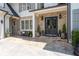 Inviting front porch with stone accents, double doors, bench, matching lanterns, and manicured landscaping at 4559 Paradise Shoals Se Rd, Atlanta, GA 30339