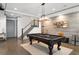Game room features a pool table, hardwood floors, stairs, and stylish decor at 4559 Paradise Shoals Se Rd, Atlanta, GA 30339