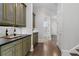 Hallway features rich hardwood floors, custom cabinetry, and a view into the powder room at 4559 Paradise Shoals Se Rd, Atlanta, GA 30339