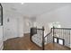 Elegant upstairs hallway with hardwood floors and wrought iron railing at 4559 Paradise Shoals Se Rd, Atlanta, GA 30339