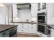 Gourmet kitchen with stainless steel appliances, herringbone backsplash and ample counter space at 4559 Paradise Shoals Se Rd, Atlanta, GA 30339