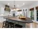 Modern kitchen with gray center island, black counter tops, stainless steel appliances and breakfast bar at 4559 Paradise Shoals Se Rd, Atlanta, GA 30339