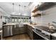 Spacious kitchen with stainless steel appliances, modern sink, and wood shelves at 4559 Paradise Shoals Se Rd, Atlanta, GA 30339