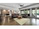 Open-concept living room featuring hardwood floors, large windows, and comfortable seating at 4559 Paradise Shoals Se Rd, Atlanta, GA 30339
