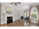 Open living room features hardwood floors, a fireplace, and large windows that provide natural light at 4559 Paradise Shoals Se Rd, Atlanta, GA 30339