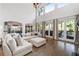 Bright living room with hardwood floors, large windows and doors leading to the outdoor living space at 4559 Paradise Shoals Se Rd, Atlanta, GA 30339