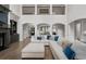 Open-concept living room with tall ceilings, hardwood flooring, and large comfortable sofa at 4559 Paradise Shoals Se Rd, Atlanta, GA 30339