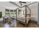 Comfortable main bedroom featuring a four-poster bed, tray ceiling, and large windows at 4559 Paradise Shoals Se Rd, Atlanta, GA 30339