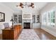 Well-lit home office with a built-in fireplace, custom shelving and large window allowing for ample natural light at 4559 Paradise Shoals Se Rd, Atlanta, GA 30339