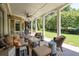 Covered patio with stone pillars, a ceiling fan, and comfortable seating overlooking the backyard at 4559 Paradise Shoals Se Rd, Atlanta, GA 30339
