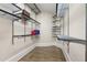 Organized walk-in closet with adjustable shelving and hardwood floors at 4559 Paradise Shoals Se Rd, Atlanta, GA 30339
