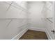 Spacious walk-in closet with wooden floors and metal racks for optimal storage and organization at 4559 Paradise Shoals Se Rd, Atlanta, GA 30339