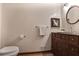 Cozy bathroom with a wooden vanity, circular mirror, and a classic-style faucet at 4810 Lismoor Trce, Mableton, GA 30126