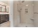 Modern bathroom boasts a tiled shower with a built-in niche, a rain shower head, and a seat at 4810 Lismoor Trce, Mableton, GA 30126