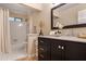 Well-lit bathroom with a shower-tub combination and a dark vanity with a light countertop at 4810 Lismoor Trce, Mableton, GA 30126